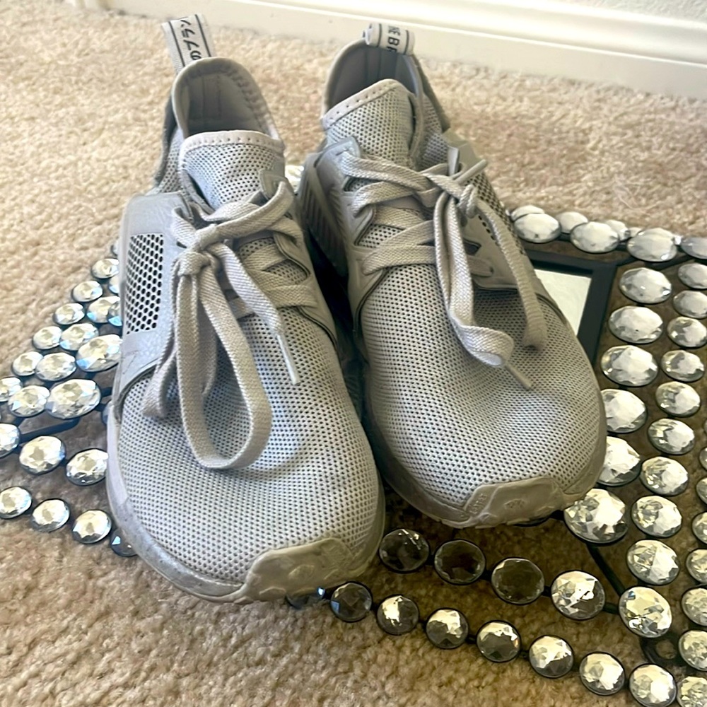 Mens size 7, Women’s size 9, Grey Adidas NMD athletic shoes.